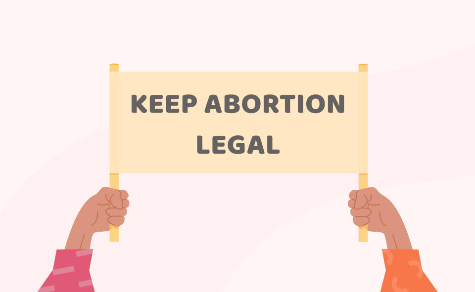 Hands holding a sign that says Keep Abortion Legal