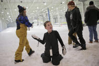 Mikey Mastrianni, 8, threatens his family with a snowball before the grand opening of Big Snow in East Rutherford, N.J., Thursday, Dec. 5, 2019. The facility, which is part of the American Dream mega-mall, is North America's first indoor ski and snowboard facility with real snow. (AP Photo/Seth Wenig)