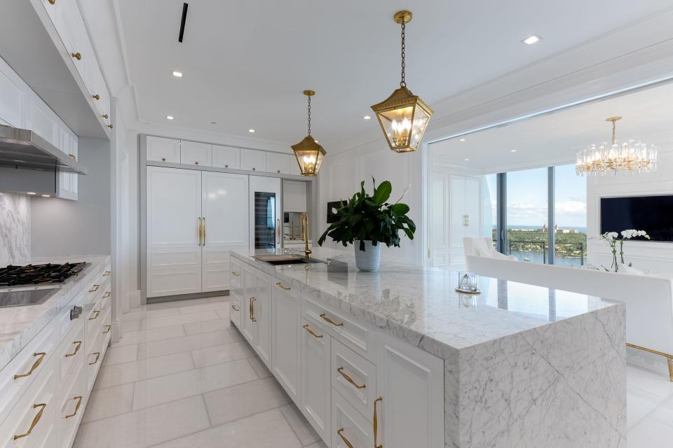 With a marble work island, the remodeled kitchen is open to living area but can be closed off with pocket doors.