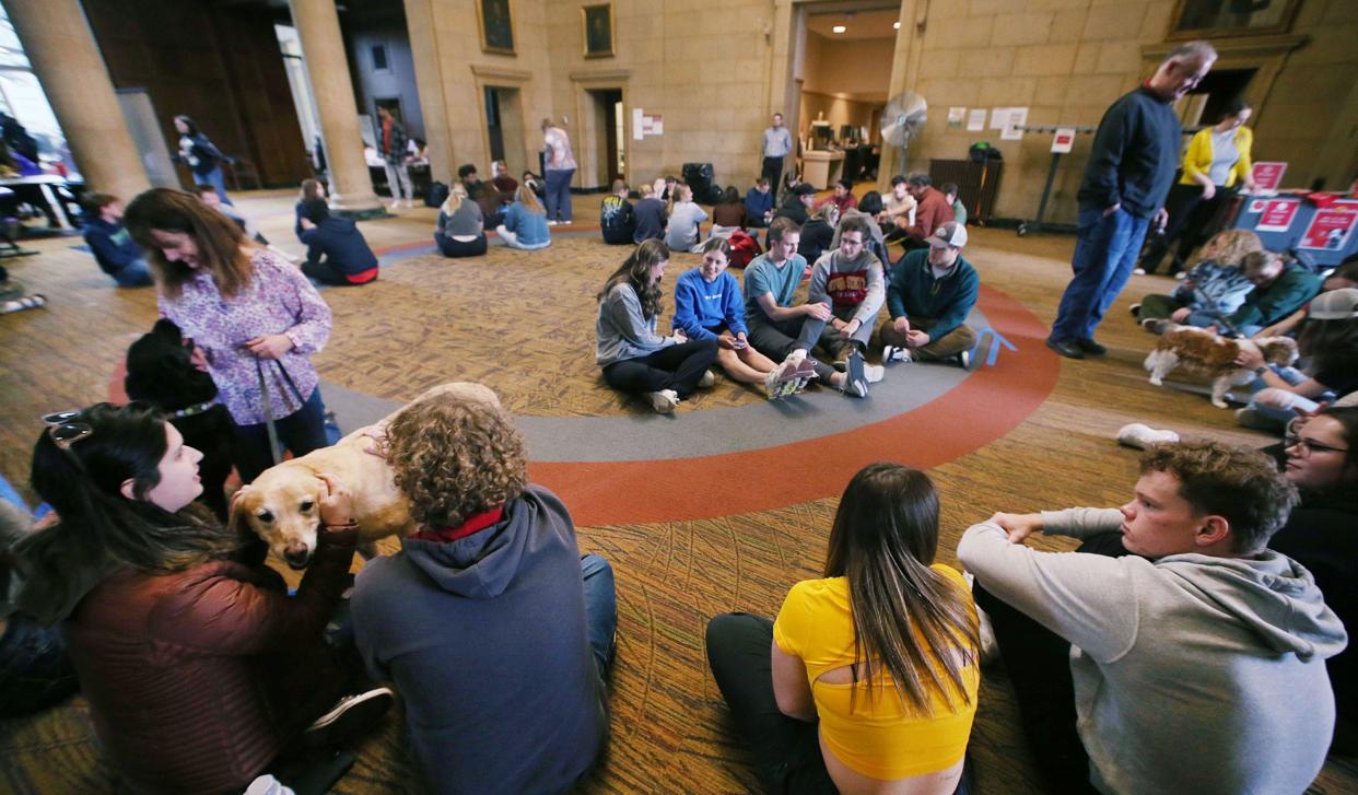 Iowa State University students pet therapy dogs at the “Barks at Parks” event at the university’s Parks Library on Monday, April 29, 2024, in Ames, Iowa. The university students are invited to participate in the event to destress from the finals in Prep Week by petting certified therapy dogs.