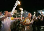 <p>Model Adriana Lima carries the Olympic torch with Rio de Janeiro’s Secretary of Tourism Antonio Pedro in Maua Square in Rio de Janeiro, Brazil, August 4, 2016. REUTERS/Pilar Olivares </p>