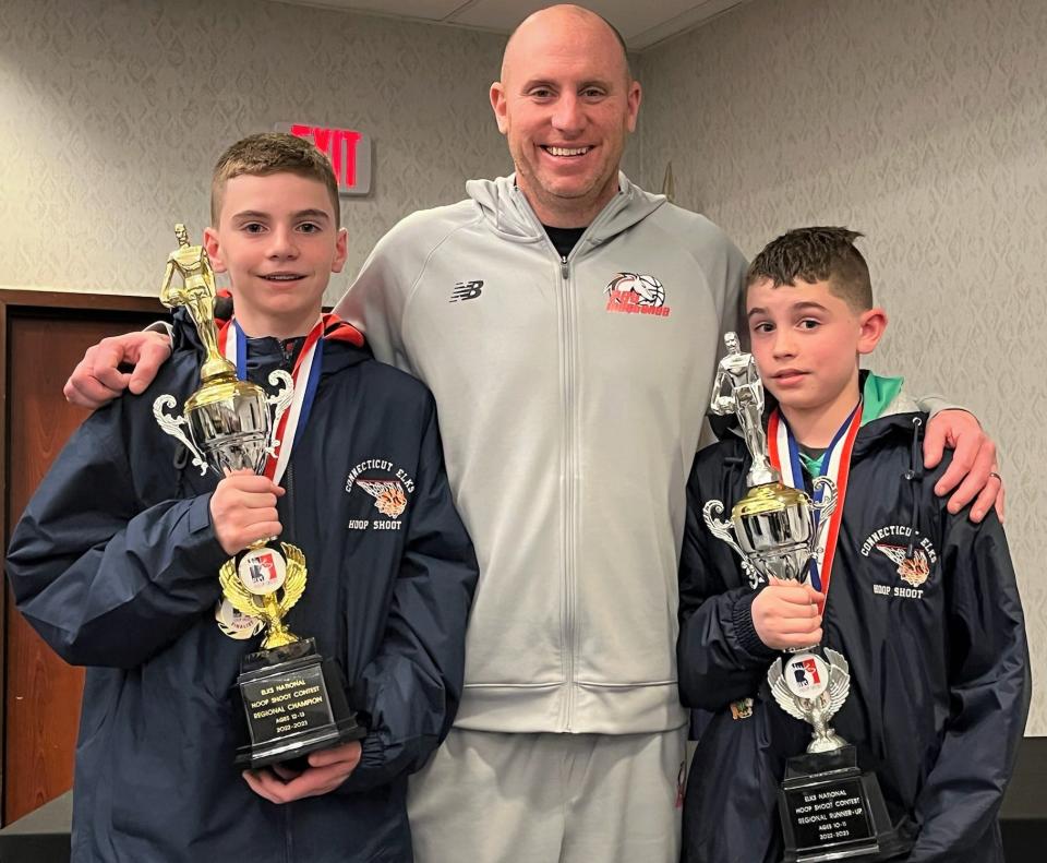 Putnam Science Academy coach Tom Espinosa celebrates with his sons TJ and Bryce at the Elks Free Throw regional championship in Maine. TJ, left, advanced to the national finals in Chicago (April 20-23).