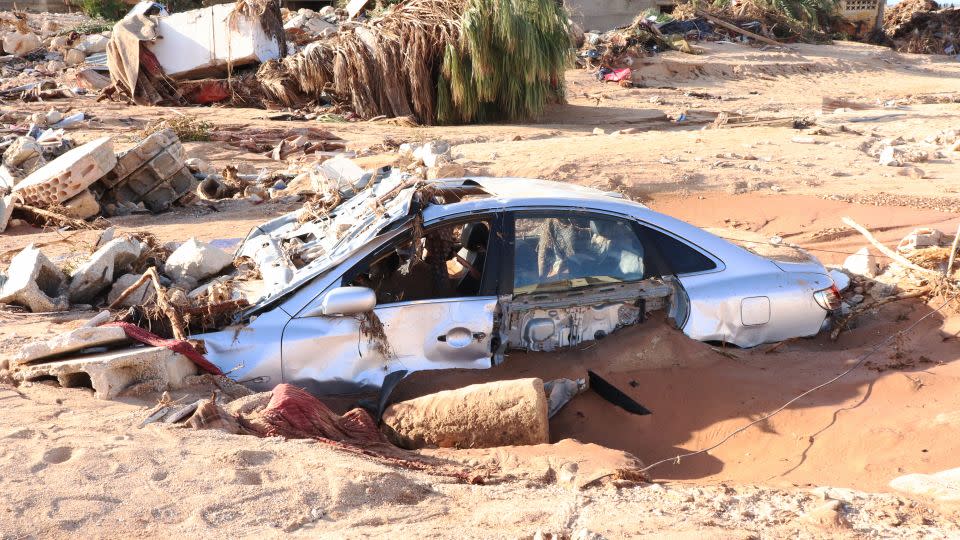 A damaged vehicle is stuck in debris after the floods caused by Storm Daniel in Derna on September 12. - Abdullah Mohammed Bonja/Anadolu Agency/Getty Images