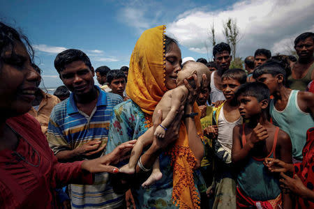 Hamida, a Rohingya refugee woman, weeps as she holds her 40-day-old son after he died as their boat capsized before arriving on shore in Shah Porir Dwip, Teknaf, Bangladesh, September 14, 2017. REUTERS/Mohammad Ponir Hossain