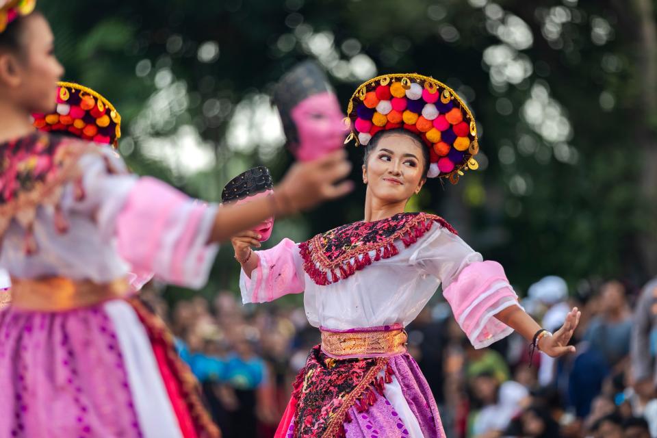Performers participate in a cultural parade in Bali (EPA)
