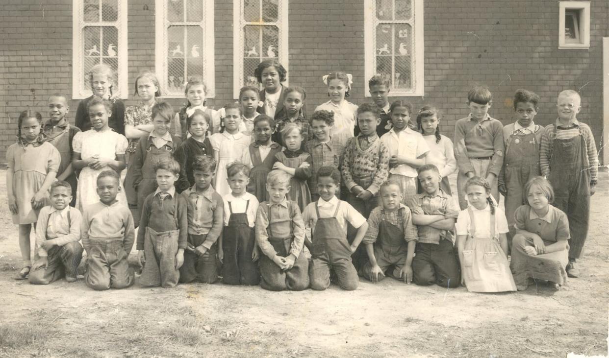 <span class="caption">Students of School Section #13 with teacher, Verlyn Ladd, who taught at the school from 1939 to 1958. Class of 1951, Buxton, Raleigh Township, Ontario. </span> <span class="attribution"><span class="source">(Buxton National Historic Site & Museum)</span>, <span class="license">Author provided</span></span>