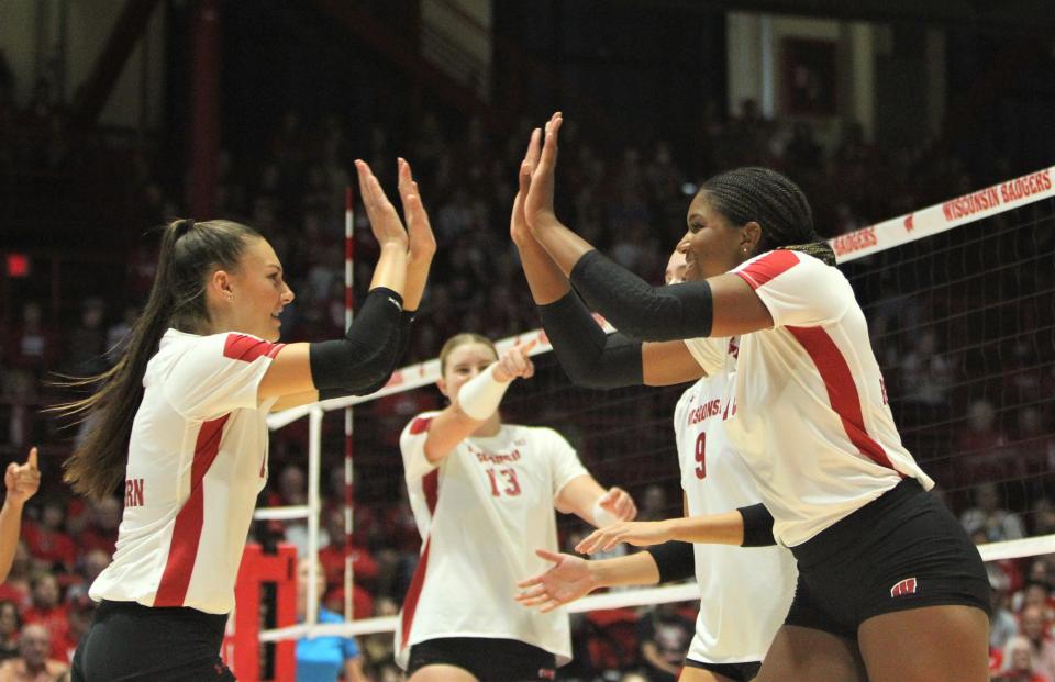 Wisconsin's Izzy Ashburn (left) and Devyn Robinson celebrate a point during the volleyball team's sweep of Indiana at the UW Field House in Madison, Wis. on Sunday Sept. 23, 2023.