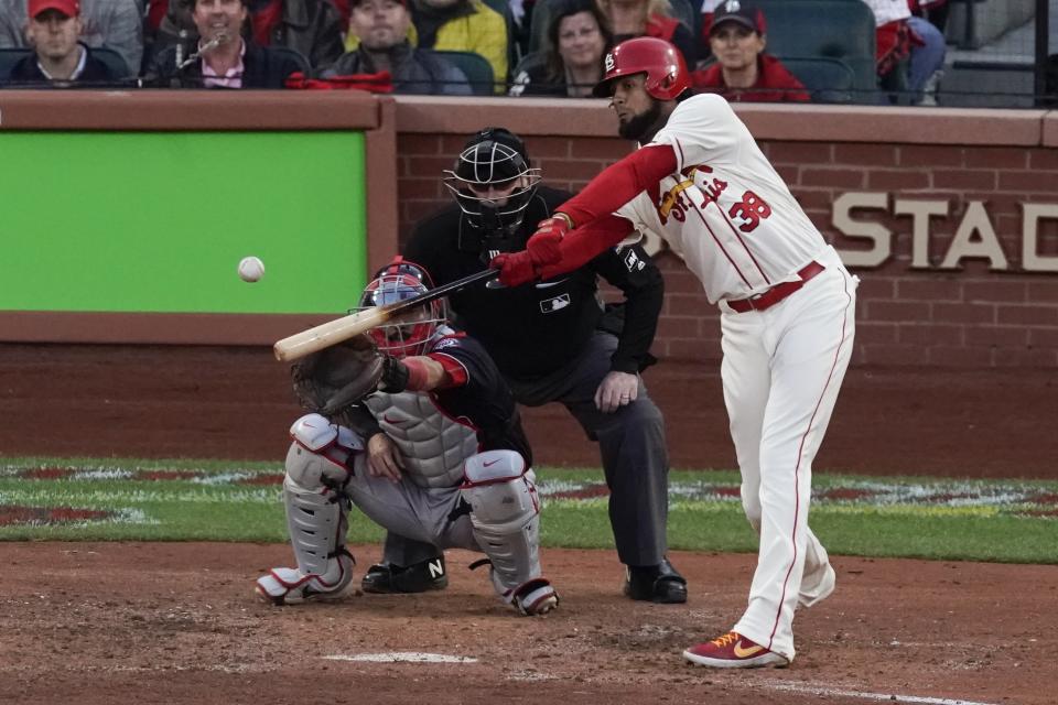 St. Louis Cardinals' Jose Martinez hits an RBI double during the eighth inning of Game 2 of the baseball National League Championship Series against the Washington Nationals Saturday, Oct. 12, 2019, in St. Louis. (AP Photo/Charlie Riedel)