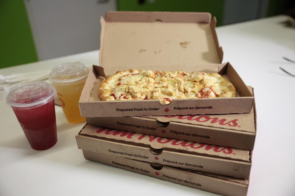 An open box of flatbread pizza sitting on top of two more boxes. Two drinks in transparent plastic cups sit alongside. (R.J.Johnston/Toronto Star)  R.J. Johnston/Toronto Star        (R.J. Johnston/Toronto Star via Getty Images)