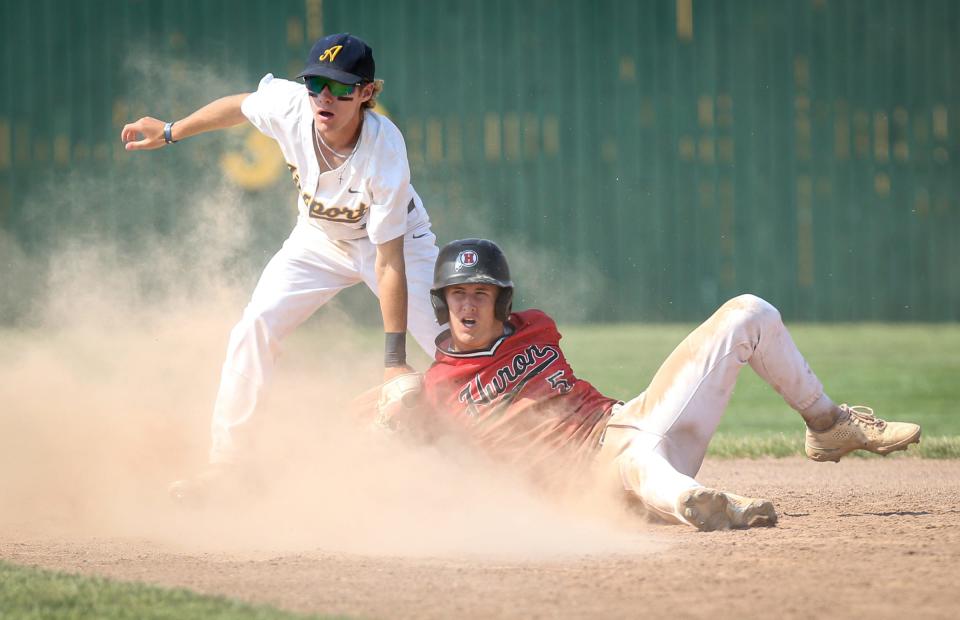 Airport's Corey Ferris tags out Micah Smith of New Boston Huron in the finals of the División 2 District at Airport Saturday. Huron won 4-1 in 10 innings.