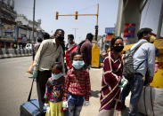 Indians line up to board trains outside New Delhi railway station in New Delhi, India, Tuesday, May 12, 2020. India is reopening some of its colossal rail network as the country looks at easing its nearly seven-week strict lockdown amid an increase in coronavirus infections. (AP Photo/Manish Swarup)