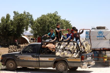 Internally displaced children sit at a back of a truck near the Israeli-occupied Golan Heights, in Quneitra, Syria June 21, 2018. REUTERS/Alaa al-Faqir