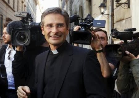 Monsignor Krzystof Charamsa smiles as he leaves at the end of his news conference in downtown Rome October 3, 2015. REUTERS/Alessandro Bianchi