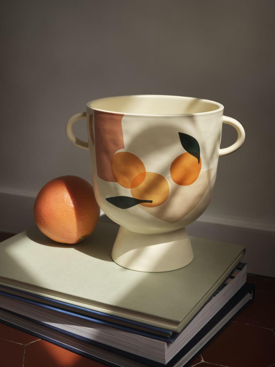 <p>This beautiful stoneware plant pot created by duo Sacrée Frangine features sun-ripened oranges on a cream background. </p><p>'Our pieces in the collection are gentle reminders to take time. Take time to dream, to contemplate a beautiful landscape, to smile, to spend time with people you love or miss,' say Célia Amroune and Aline Kpade from Sacrée Frangine.</p><p><a class="link " href="https://www2.hm.com/en_gb/productpage.1009576001.html" rel="nofollow noopener" target="_blank" data-ylk="slk:BUY NOW;elm:context_link;itc:0;sec:content-canvas">BUY NOW</a> </p>