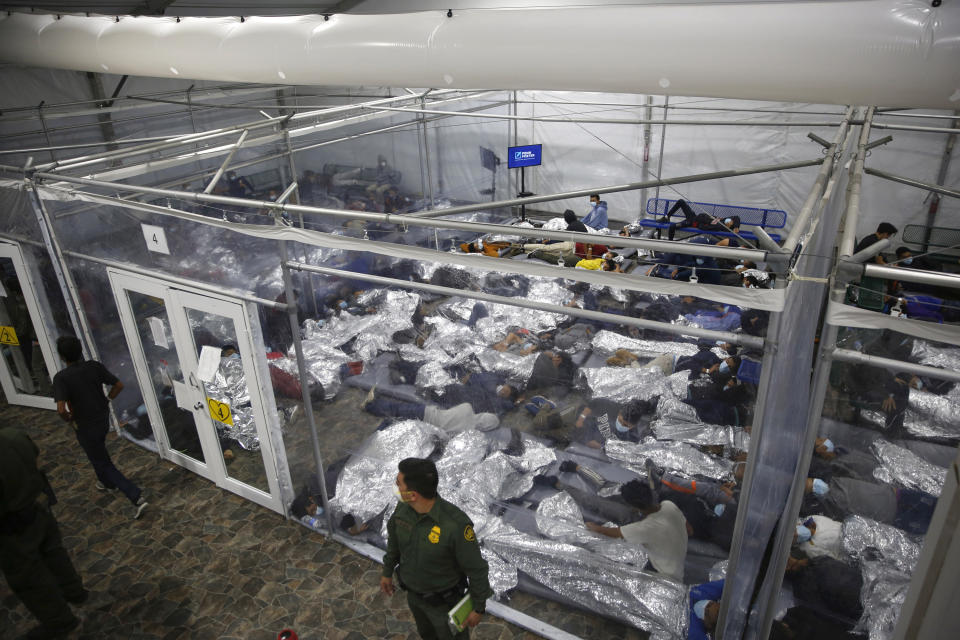 FILE - In this March 30, 2021, file photo, young minors lie inside a pod at the Donna Department of Homeland Security holding facility, the main detention center for unaccompanied children in the Rio Grande Valley run by U.S. Customs and Border Protection (CBP), in Donna, Texas. On Monday, June 21, 2021, more than a dozen immigrant children described difficult conditions, feelings of isolation and a desperation to get out of emergency facilities set up by the Biden administration to cope with a rise in the arrival of minors on the southwest border. (AP Photo/Dario Lopez-Mills, Pool, File)