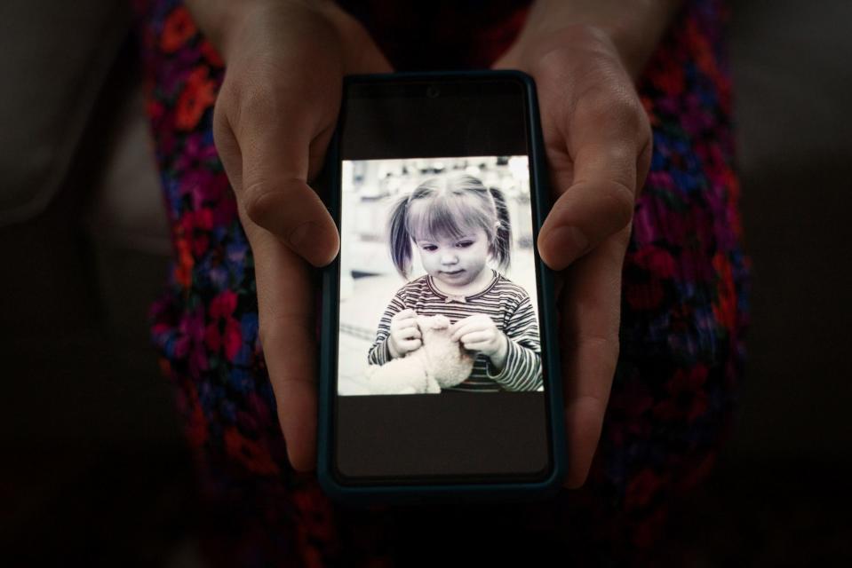 Leah Wathen, 23, holds a photo of herself as a toddler at her home in Kalamazoo on Sunday, March 26, 2023. "I didn't know who I was for so long. I was very shy and reserved, so a lot of things were just passed off as, 'Oh, she's just anxious and quirky,'" said Wathen, who was diagnosed with autism at the age of 22. "When you think of autism you think of the stereotypical child, so I never had any idea it could look like other things. Now I can ask myself, how can I be more authentic so that I'm not trying to be someone I'm not all the time?"