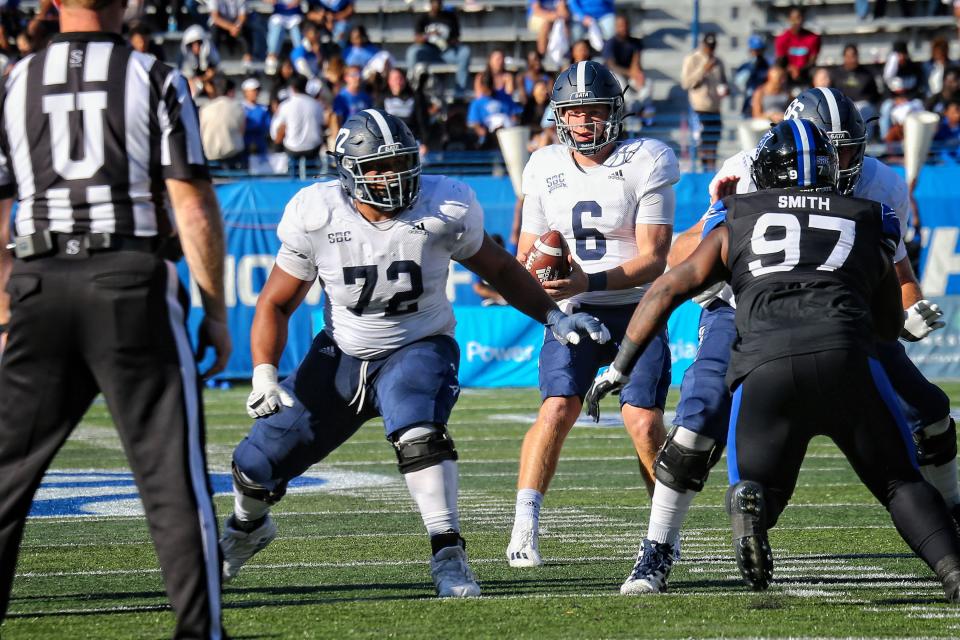 Georgia Southern quarterback Kyle Vantrease (6) takes the snap as Kalil Crowder (72) provides protection against Georgia State on Saturday at Center Parc Stadium in Atlanta. Vantreased passed for 359 yards and three touchdowns along with four interceptions.