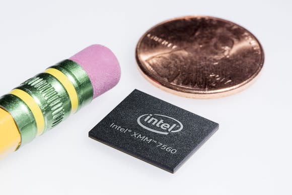 An Intel XMM 7560 LTE modem next to a pencil eraser (left) and a penny (top) for scale. It's smaller than the penny and bigger than the eraser.