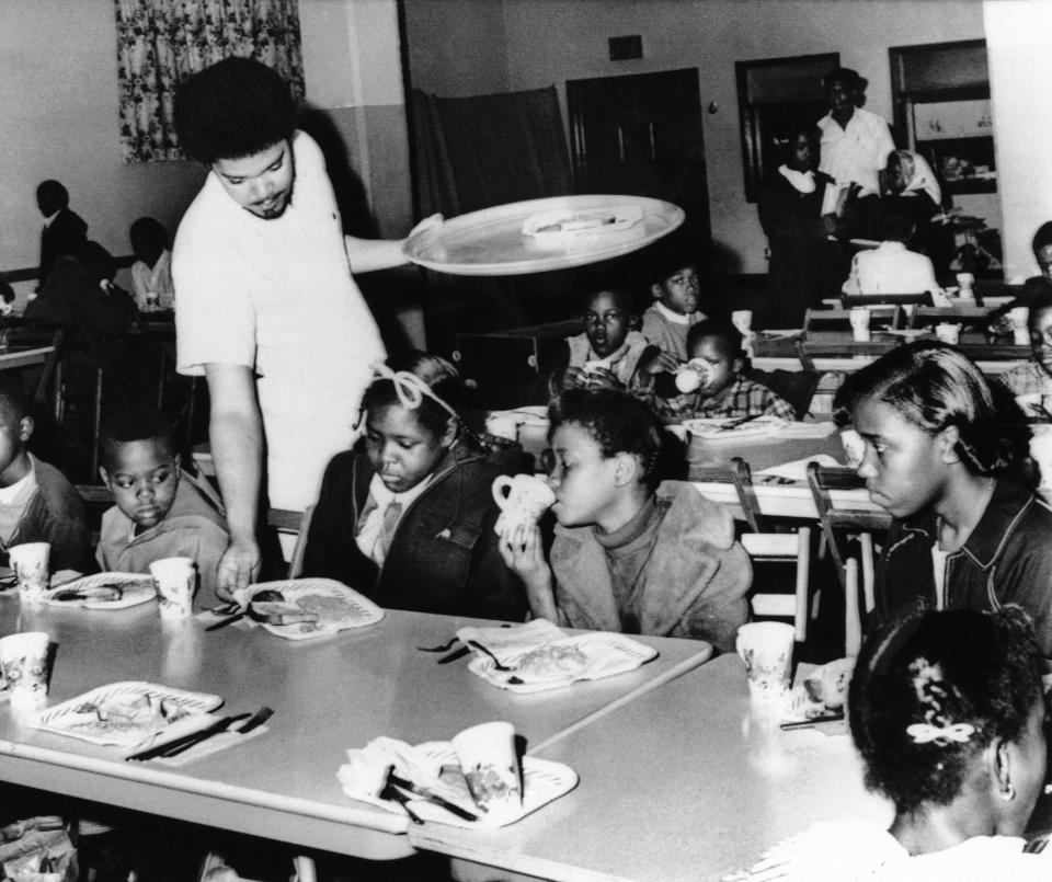 A member of the Black Panther chapter in Kansas City serves free breakfast to children in April 1969 before they go to school. The free breakfast initiative was one of what Black Panther co-founder Huey Newton called the party's "survival programs." (Photo: AP Photo/William P. Straeter)