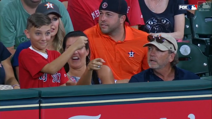 This Red Sox fan was just protecting himself after one fan interfered with a ball. (MLB.com Screenshot)