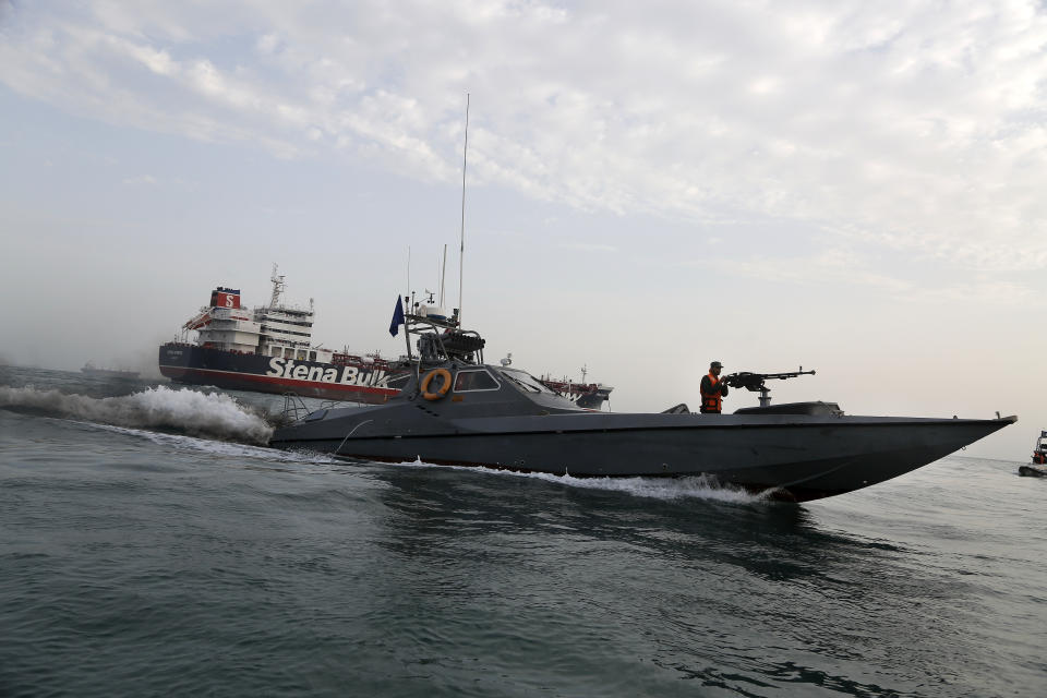 FILE - In this July 21, 2019 file photo, a speedboat of the Iran's Revolutionary Guard moves around a British-flagged oil tanker, the Stena Impero, which was seized by the Guard, in the Iranian port of Bandar Abbas. The U.S. Navy is trying to put together a new coalition of nations to counter what it sees as a renewed maritime threat from Iran. Meanwhile, Iran finds itself backed into a corner and ready for a possible conflict. It stands poised on Friday, Sept. 6, 2019, to further break the terms of its 2015 nuclear deal with world powers. (Hasan Shirvani/Mizan News Agency via AP, File)