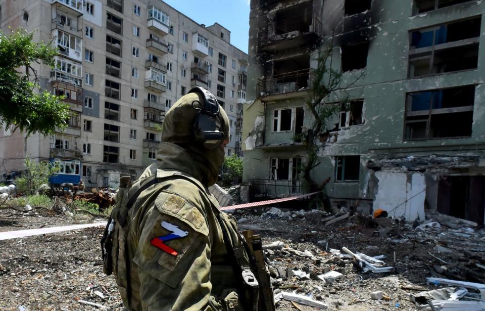A Russian soldier patrols a destroyed residential area in the city of Sievierodonetsk, Luhansk Oblast on July 12, 2022. (Olga Maltseva/AFP via Getty Images)
