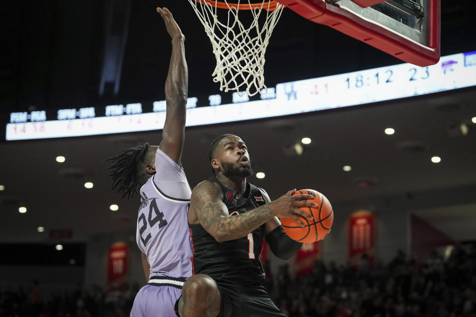 Houston guard Jamal Shead (1) drives to the basket past Kansas State forward Arthur Kaluma (24) during the second half of an NCAA college basketball game, Saturday, Jan. 27, 2024, in Houston. (Jon Shapley/Houston Chronicle via AP)