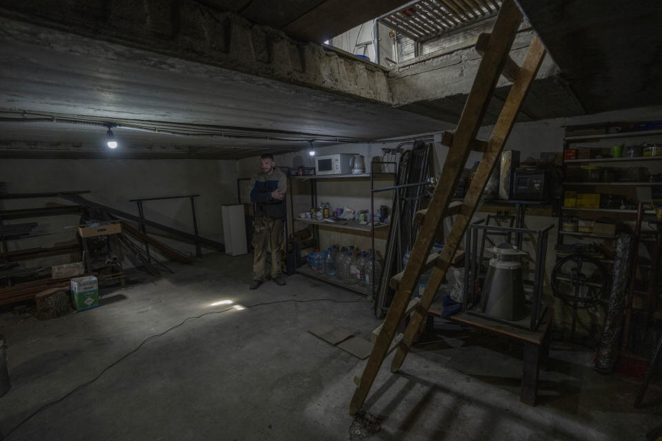 Car welder Ostap Datsenko, 31, shows the underground bunker he takes shelter in when the air siren goes off, as he works on a vehicle that will be sent to soldiers on the frontlines, at a welding workshop in Lviv, western Ukraine, Sunday, March 27, 2022. “Until yesterday it was only a basement,” Datsenko said. (AP Photo/Nariman El-Mofty)