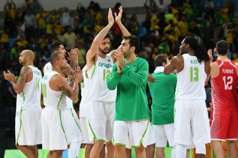 Brazil's players acknowledge the public after a men's basketball match on August 11, 2016 during the Rio Olympic Games