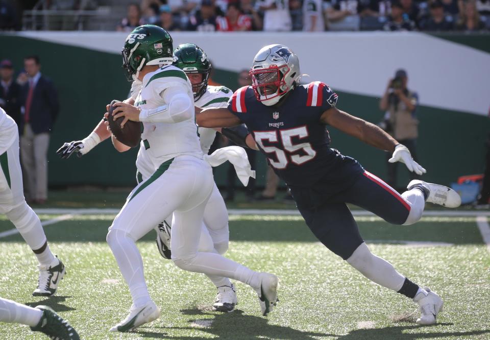 The Patriots' Josh Uche rushes Jets quarterback Zach Wilson during the game at Gillette Stadium on Sept. 19.