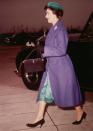 <p>Princess Margaret arrives at the Strowger Works in Liverpool, wearing a purple coat, green dress, and matching hat.</p>