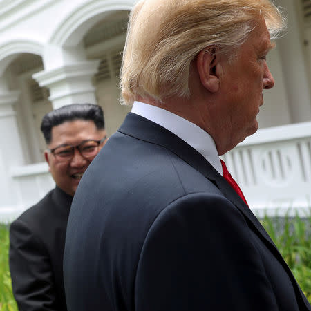 U.S. President Donald Trump and North Korea's leader Kim Jong Un walk together before their working lunch during their summit at the Capella Hotel on the resort island of Sentosa, Singapore, June 12, 2018. Reuters photographer Jonathan Ernst: "On a historic and difficult day, it was fun to look for the odd angle or expression. Here, Trump and Kim walk away after impromptu remarks to reporters - which clearly pleased the North Korean leader." REUTERS/Jonathan Ernst