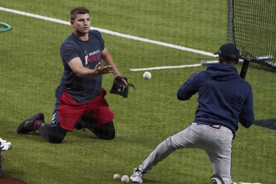 Atlanta Braves' Austin Riley, left, fields balls from third base coach Ron Washington, right, during workouts before the National League Championship Series against the Los Angeles Dodgers in Arlington, Texas, Sunday, Oct 11, 2020. The series begins Monday, Oct. 12. (AP Photo/Sue Ogrocki)