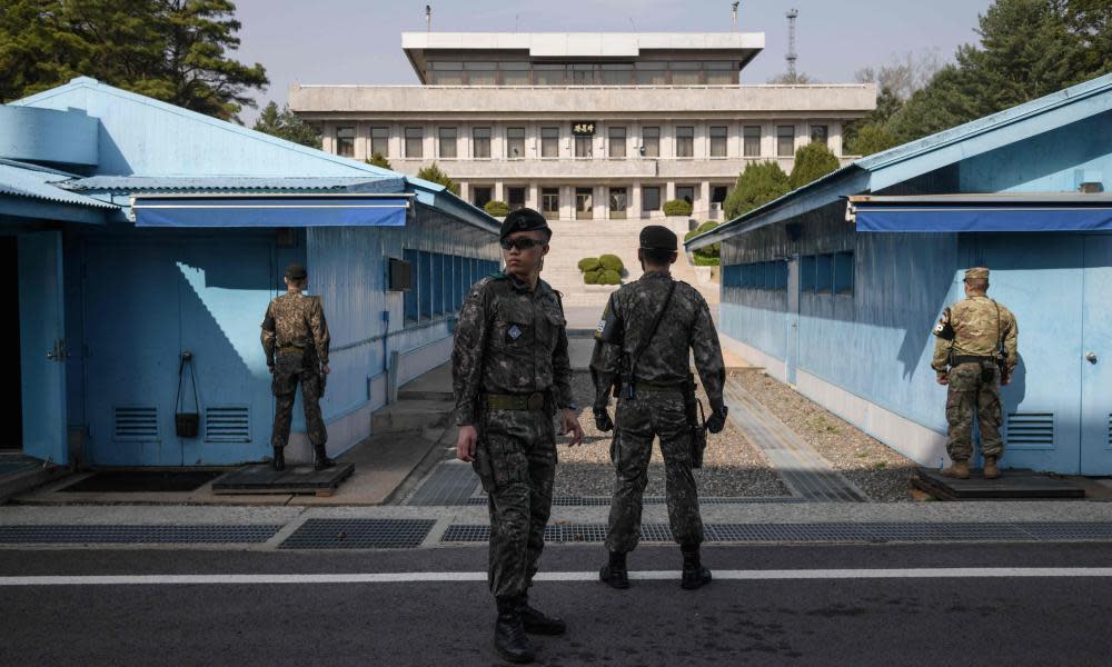 South Korean soldiers standing guard outside a meeting hut in the truce village of Panmunjom within the Demilitarized Zone.