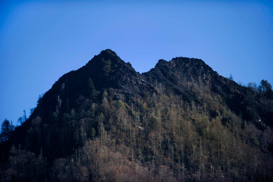 Dec 2, 2016; Gatlinburg, TN, USA; The wildfire-scarred Chimney Tops is pictured in the Great Smoky Mountains National Park. Officials say the fire that has killed 13 people and destroyed more than 700 structures started here on Nov  23. The fire is human caused and under investigation. Mandatory Credit: Paul Efird/Knoxville News Sentinel via USA TODAY NETWORK