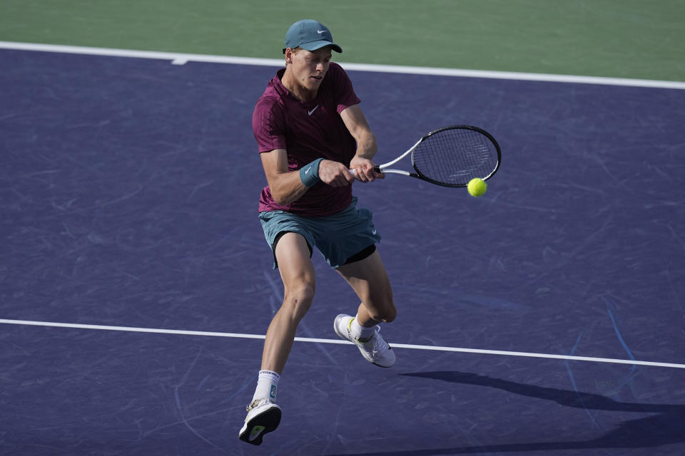 Jannik Sinner, of Italy, returns a shot against Carlos Alcaraz, of Spain, during a semifinal match at the BNP Paribas Open tennis tournament Saturday, March 18, 2023, in Indian Wells, Calif. (AP Photo/Mark J. Terrill)
