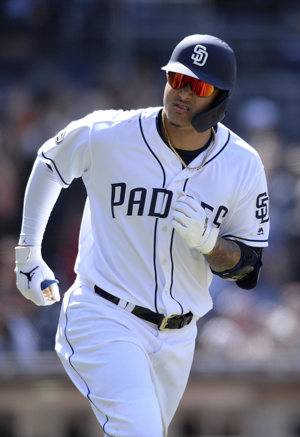 San Diego Padres' Manny Machado looks over to the dugout as he rounds the bases after hitting a two-run home run during the seventh inning of a baseball game against the Arizona Diamondbacks Wednesday, April 3, 2019, in San Diego. (AP Photo/Orlando Ramirez)