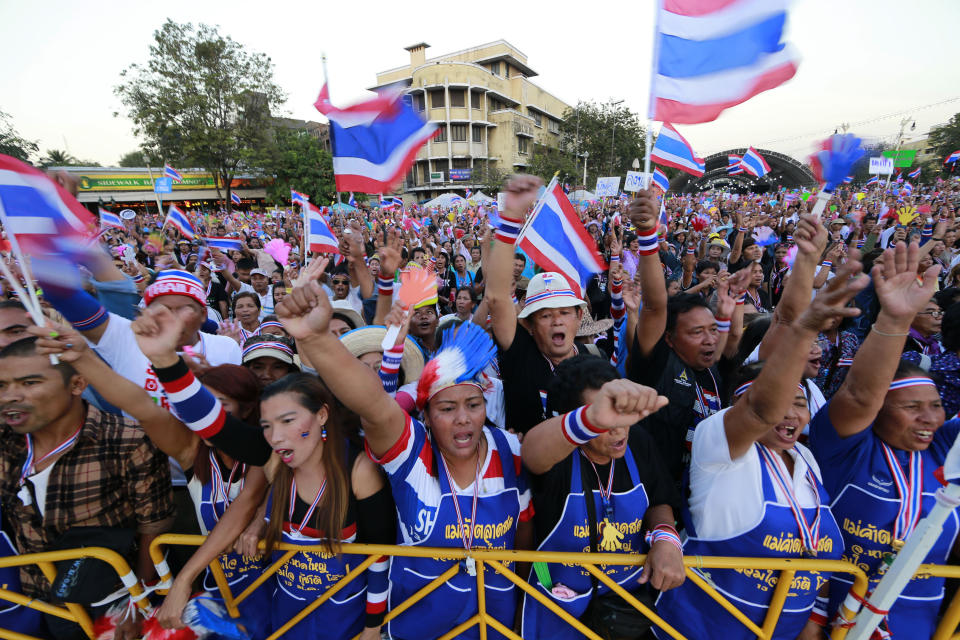 Thai anti-government protesters shout and cheer during a rally at the Democracy Monument in Bangkok, Sunday, Jan. 12, 2014. Anti-government demonstrators were preparing Sunday to occupy major intersections of Thailand's congested capital in what they say is an effort to shut down Bangkok, a plan that has raised fears of violence that could trigger a military coup. (AP Photo/Wason Wanichakorn)