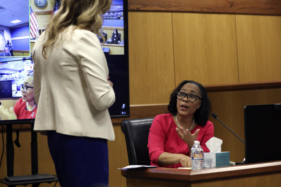 Ashleigh Merchant, left, attorney for Michael Roman, questions Fulton County District Attorney Fani Willis during a hearing on the Georgia election interference case, Thursday, Feb. 15, 2024, in Atlanta. The hearing is to determine whether Willis should be removed from the case because of a relationship with Nathan Wade, special prosecutor she hired in the election interference case against former President Donald Trump. (Alyssa Pointer/Pool Photo via AP)
