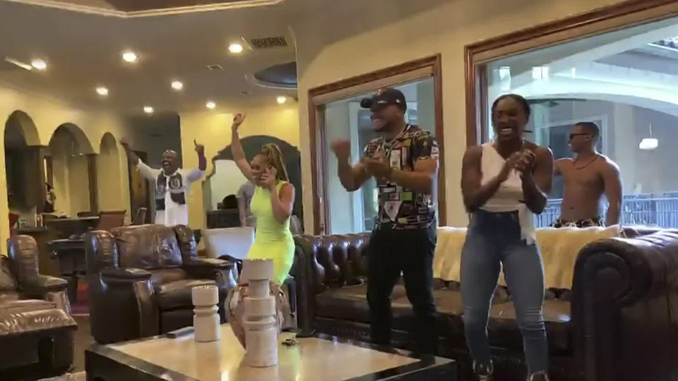 In this still image from video provided by the NFL, Antoine Winfield Jr., wearing cap, celebrates after being selected by the Tampa Bay Buccaneers during the second round of the NFL football draft, Friday, April 24, 2020. (NFL via AP)