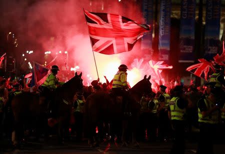 Flares are let off as police stand guard while pro-union protestors clash with pro-independence protestors during a demonstration at George Square in Glasgow, Scotland September 19, 2014. REUTERS/Cathal McNaughton