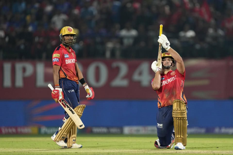 Punjab Kings' Rilee Rossouw, right, celebrates his fifty runs as teammate Shashank Singh looks on during the Indian Premier League cricket match between Punjab Kings and Royal Challengers Bengaluru in Dharamshala, India, Thursday, May 9, 2024. (AP Photo /Ashwini Bhatia)