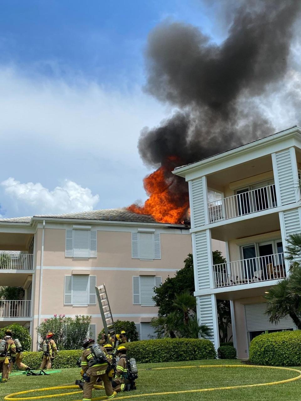 Firefighters battle a fire that broke out on the roof of a three-story beachside condominium building in south county around 2 pm June 30, 2022. Smoke billowed from the top of the southeast building of the u-shaped Southwinds complex in the 2200 block of North Southwinds Drive on State Road A1A. No one was injured.