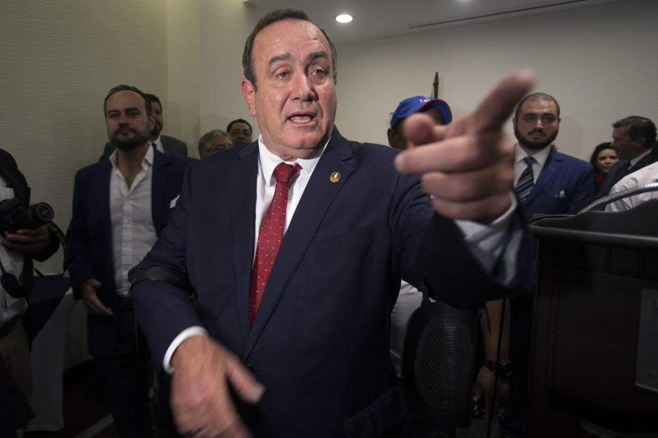 FILE - In this June 13, 2019, file photo, Alejandro Giammattei, presidential candidate of the Vamos political party, speaks with reporters during a press conference prior to June 16 general elections in Guatemala City. (AP Photo/Moises Castillo, File)