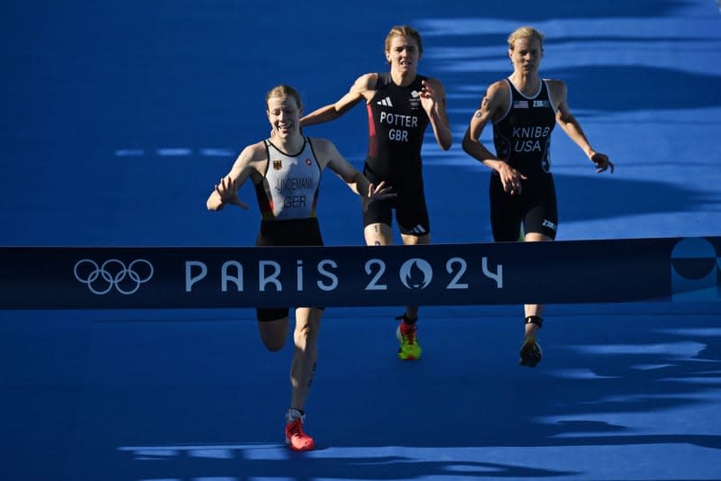 Germany win mixed triathlon as swimming takes place despite illness