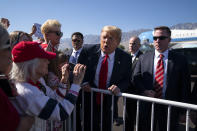 President Donald Trump greets supporters after arriving at Palm Springs International Airport, in Palm Springs, Calif., en route to a fundraiser in Rancho Mirage, Calif., Wednesday, Feb. 19, 2020, in Palm Springs, Calif. (AP Photo/Evan Vucci)