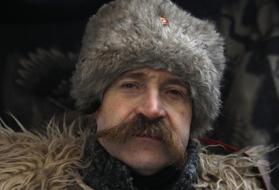 A Cossack poses for a picture in a demonstrators' camp during a rally held by anti-government protesters in Independence Square in central Kiev