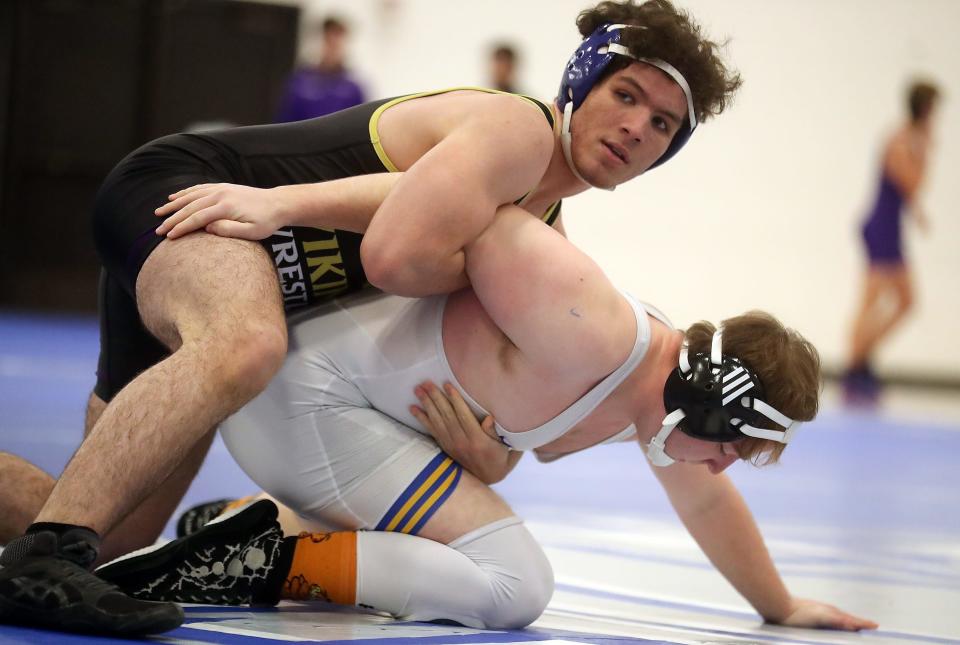 North Kitsap's Zakaria Hammou looks to coach Robert Gomez as he puts a hold on Bremerton's Colby Furniss during their 220-pound bout on Wednesday, Dec. 14, 2022.