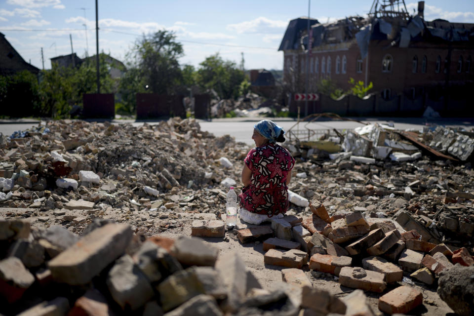 Melania rests as she works clearing the rubble of a temple that was destroyed during attacks in Gorenka, on the outskirts of Kyiv, Ukraine, Monday, June 6, 2022. (AP Photo/Natacha Pisarenko)