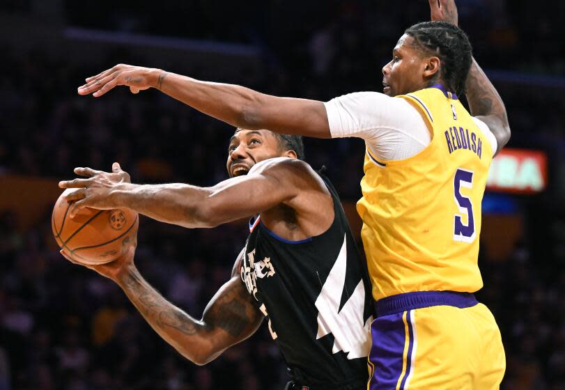 Los Angeles, California November 1, 2023-Clippers Kawhi Leonard is fouled by Lakers Cam Reddish while driving to the basket in the second quarter at Crypto.com Wednesday. (Wally Skalij/Los Angeles Times)